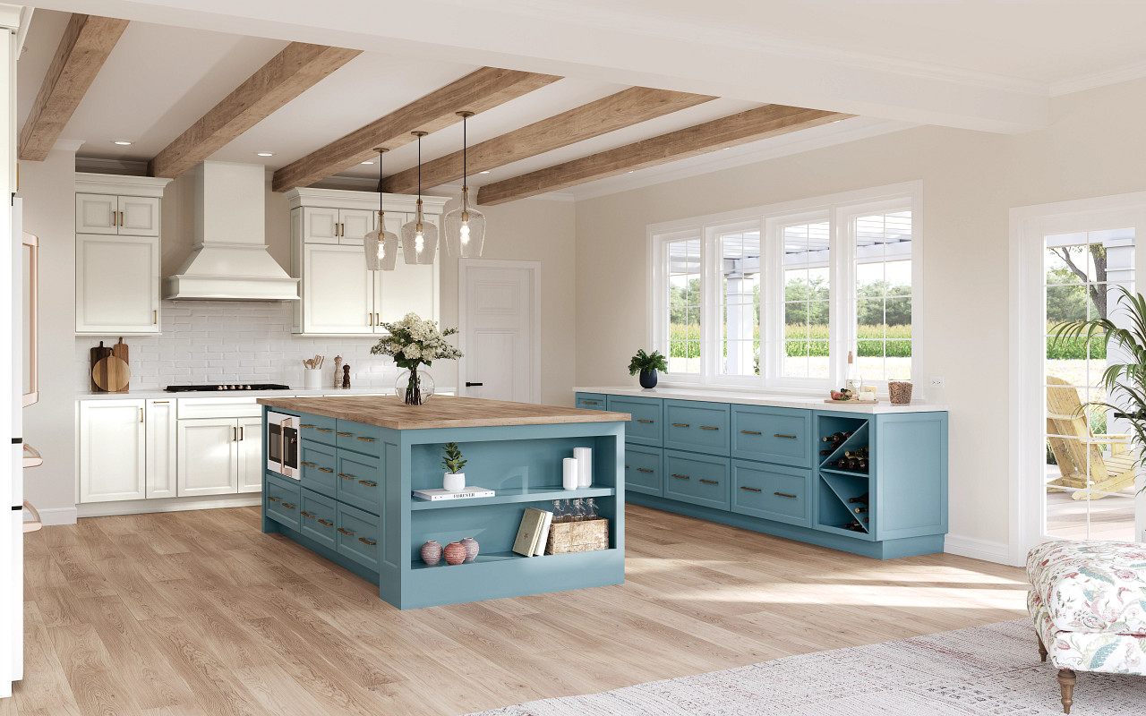 Coastal kitchen with white cabinetry, blue island, and light wood flooring
